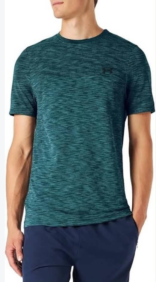 Under Armour Vanish Mens Seamless Running (Category: Activewear) located in Meycauayan. Submitted by epicforest_231b9d (Listing ID 1468396519, Image 2). Description: - Brand: Under Armour Vanish Men's Seamless Running Shirt - Color: Teal Heather - Size: XL (22" width x 32" length) - Material: Lightweight, breathable athletic fabric - Design: Subtle vertical Under Armour branding down the back - Condition: Excellent, zero flaws, snags, or stains -