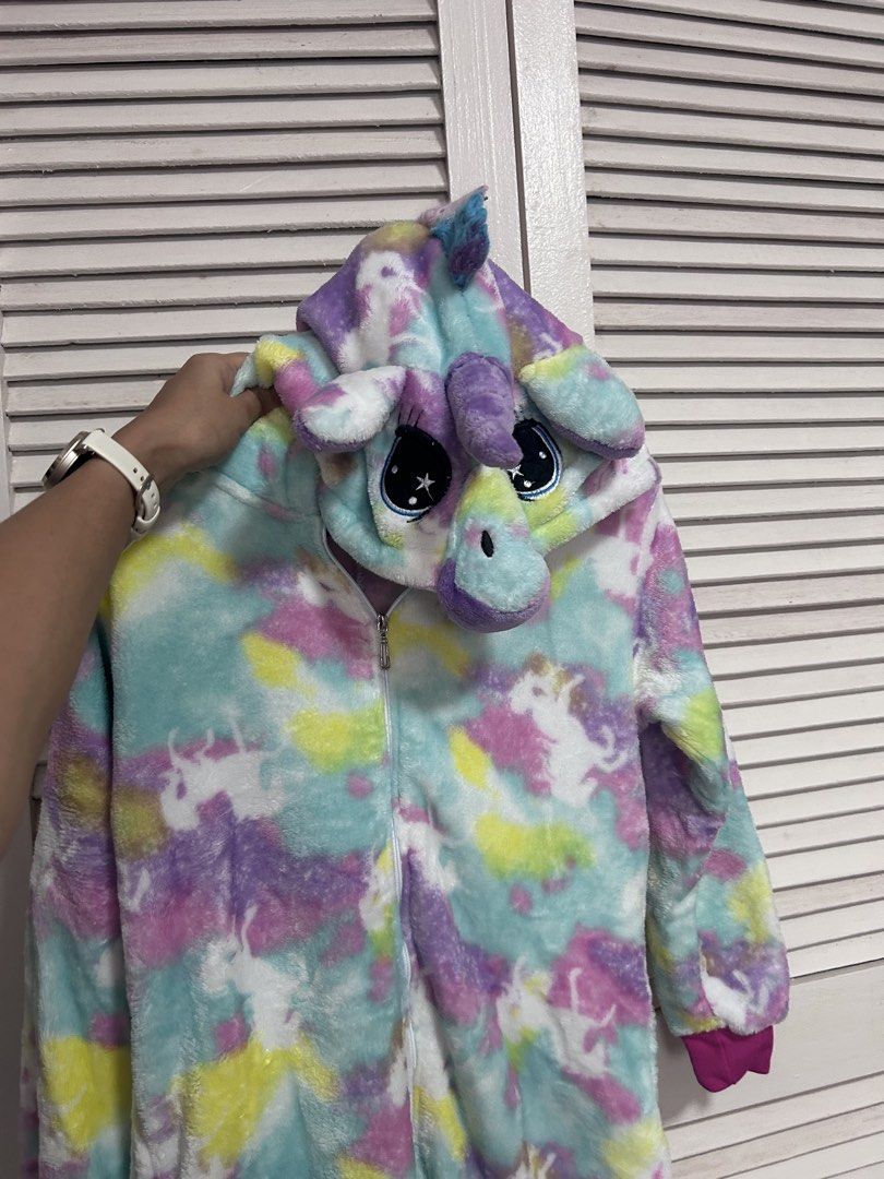Unicorn Onesie Pajamas Multicolour Fleece (Category: Babies & Kids Fashion) located in Manila. Submitted by treenitea (Listing ID 1468307112, Image 2). Description: - Super soft fleece material in pastel tie-dye (pink, blue, yellow, purple) - Full front zipper closure for easy wear - Adorable hood featuring embroidered eyes, ears, horn, and mane - Matching fluffy tail attached at the back - Bright pink ribbed cuffs on sleeves and ankles - Perfect