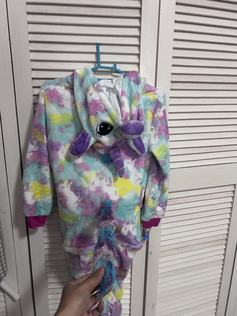 Unicorn Onesie Pajamas Multicolour Fleece (Category: Babies & Kids Fashion) located in Manila. Submitted by treenitea (Listing ID 1468307112, Image 3). Description: - Super soft fleece material in pastel tie-dye (pink, blue, yellow, purple) - Full front zipper closure for easy wear - Adorable hood featuring embroidered eyes, ears, horn, and mane - Matching fluffy tail attached at the back - Bright pink ribbed cuffs on sleeves and ankles - Perfect