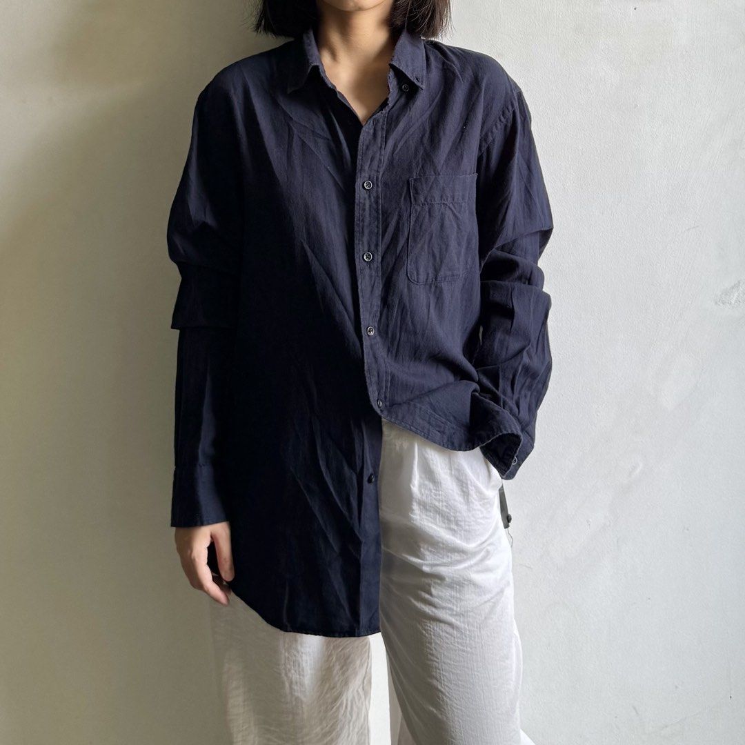 Uniqlo Dark Navy Button Down Longsleeves (Category: Shirts) located in Bulacan. Submitted by _arislmt (Listing ID 1468499522, Image 1). Description: - Color: Dark navy blue - Fit: Relaxed, oversized - Details: Long sleeves with folded cuffs, single chest pocket, standard collar - Fabric: Light and comfortable - Styling: Great for daily casual wear, easy to match with denim or white pants - Size M on tag, fits up to L.