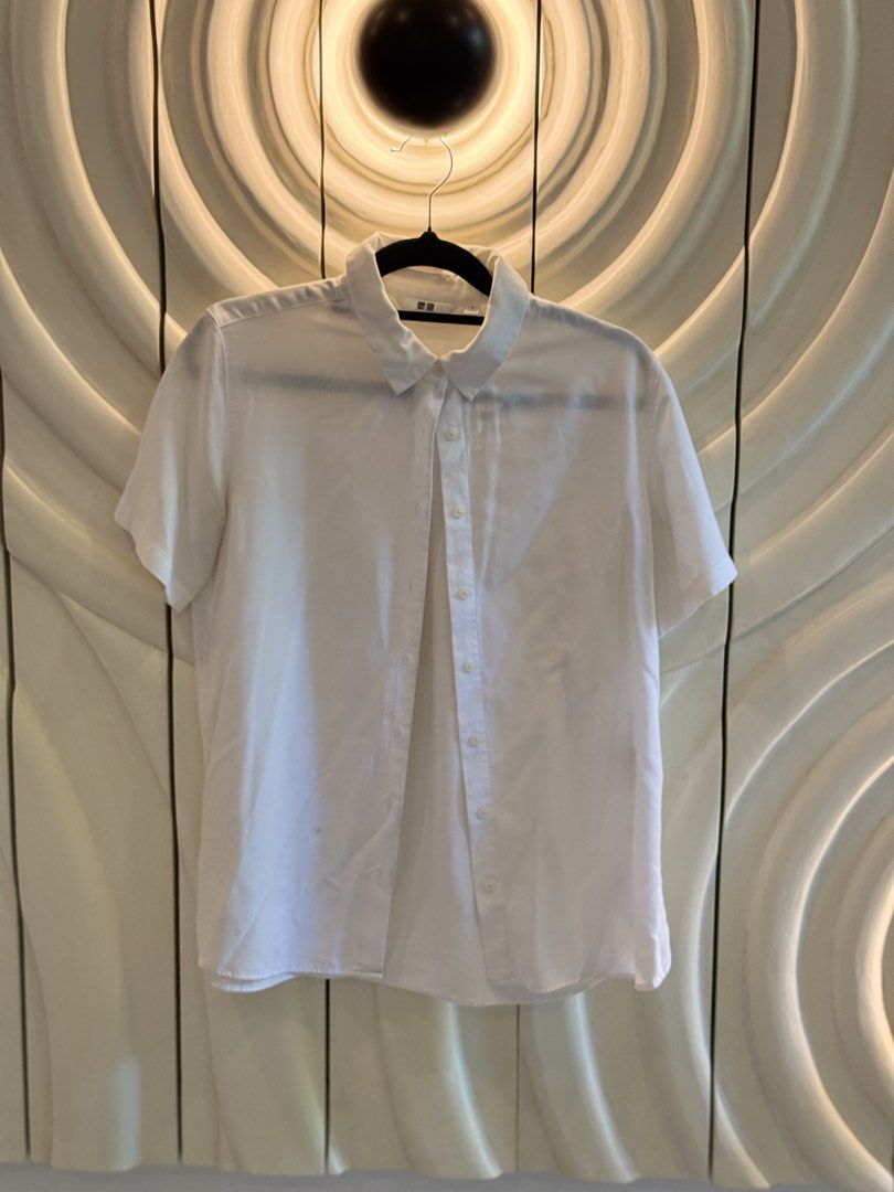 Uniqlo White Button Up Shirt Size S (Category: Shirts) located in Angeles City. Submitted by adeclutters__ (Listing ID 1468340419, Image 3). Description: - Brand: Uniqlo - Item: White button-up shirt - Size: Small - Design: Classic collared neckline with front button closure - Material: Lightweight and easy to style - Occasion: Perfect for work or casual outings - Condition: Clean and ready to wear 600 for 2.