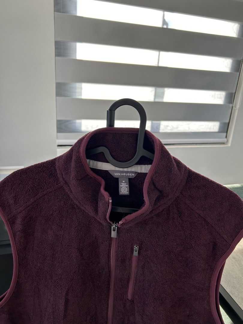 Van Heusen Fleece Vest (M) (Category: Vests) located in Dasmarinas. Submitted by sfclosetcleanup (Listing ID 1468344210, Image 2). Description: - Brand: Van Heusen - Color: Deep maroon - Size: Medium - Material: Soft fleece throughout - Closure: Full front zip - Pockets: 1 vertical chest zip pocket, 2 open hand pockets - Collar: Stand-up collar for extra warmth.