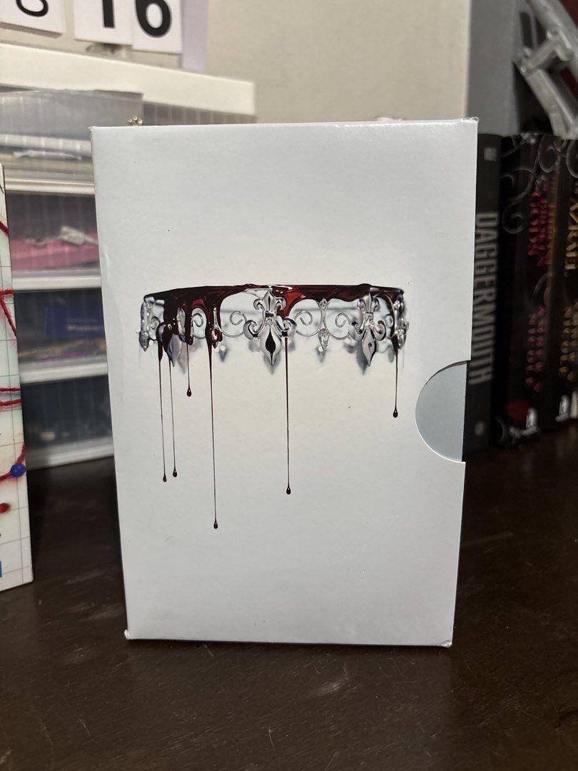 Victoria Aveyard Red Queen Series Complete Box Set (Category: Storybooks) located in Tanauan. Submitted by jessyguce (Listing ID 1468444137, Image 2). Description: - Complete NYT Bestselling Series: Includes Red Queen, Glass Sword, King's Cage, War Storm, and Broken Throne - Format: Paperback editions in the original slipcase box - Author: Victoria Aveyard - Condition: Books are well-kept, with slight shelf wear along the top and bottom edges of 