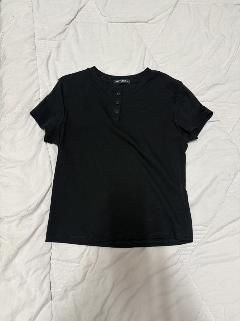 Victory Clothing Black Button Henley Tee Size L (Category: Shirts) located in Manila. Submitted by unclutterwme (Listing ID 1468427544, Image 1). Description: - Brand: Victory Clothing - Size: Large - Color: Classic Black - Material: Soft ribbed cotton - Design: Scoop neckline with 3 front buttons - Style: Casual basic, easy to pair with jeans or skirts.