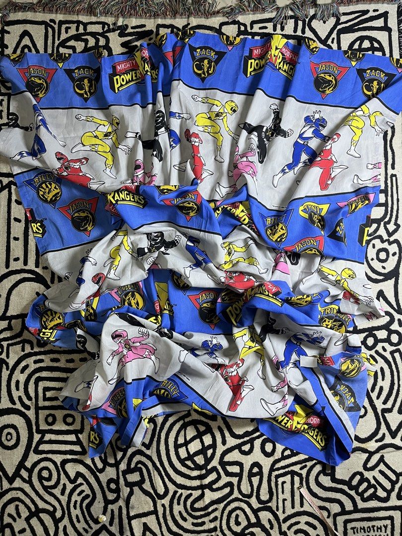Vintage 1994 Mighty Morphin Power Rangers Bed Sheet (Category: Bedding & Towels) located in Silang. Submitted by yusthrift (Listing ID 1468367036, Image 3). Description: - Official 1994 Saban Mighty Morphin Power Rangers bed sheet - Bright blue and white pattern featuring Jason, Zack, Billy, Trini, and Kimberly - Includes iconic dino coins and logo text - Clean fabric with vibrant, well-preserved prints - A must-have classic retro bedroom piece f