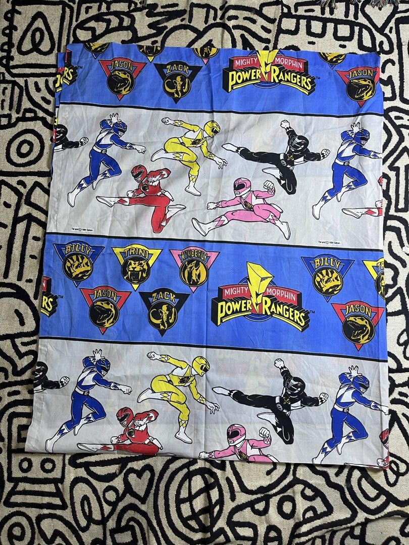 Vintage 1994 Mighty Morphin Power Rangers Bed Sheet (Category: Bedding & Towels) located in Silang. Submitted by yusthrift (Listing ID 1468367036, Image 1). Description: - Official 1994 Saban Mighty Morphin Power Rangers bed sheet - Bright blue and white pattern featuring Jason, Zack, Billy, Trini, and Kimberly - Includes iconic dino coins and logo text - Clean fabric with vibrant, well-preserved prints - A must-have classic retro bedroom piece f