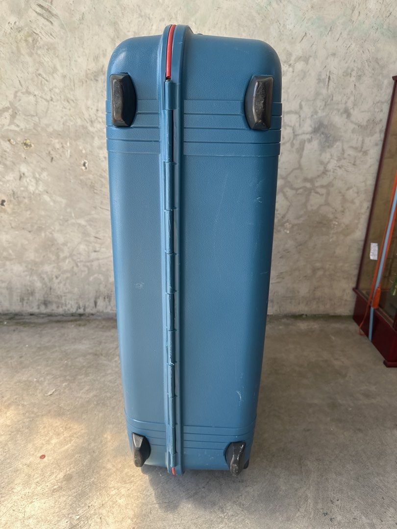 Vintage blue hard-shell suitcase with combination lock (Category: Luggage) located in Cainta. Submitted by shopbyyna (Listing ID 1468311340, Image 2). Description: - Color: Blue hard-shell with striking red trim - Security: Built-in combination lock for peace of mind - Mobility: Smooth-rolling wheels at the base and a convenient top carry handle - Durability: Heavy-duty construction with extra corner guards - Extras: Integrated name tag slot - Co