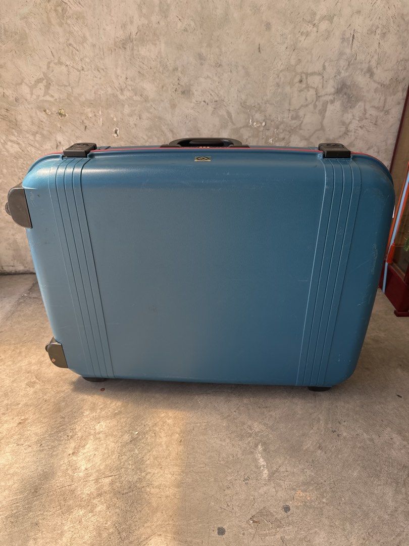 Vintage blue hard-shell suitcase with combination lock (Category: Luggage) located in Cainta. Submitted by shopbyyna (Listing ID 1468311340, Image 3). Description: - Color: Blue hard-shell with striking red trim - Security: Built-in combination lock for peace of mind - Mobility: Smooth-rolling wheels at the base and a convenient top carry handle - Durability: Heavy-duty construction with extra corner guards - Extras: Integrated name tag slot - Co