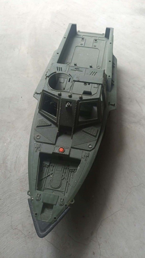 VINTAGE BOAT PLASTIC TOY (Category: Vehicle & Diecast Models) located in Mandaluyong City. Submitted by LEATHERFACE (Listing ID 1468323550, Image 2). Description: - Large green military toy boat with camo pattern and white 'S1' lettering - Detailed cockpit area and open cargo deck in the back - Functional red button near the front bow - Durable plastic hull construction with minor scuffs from regular play - Note: Missing top canopy roof piece and