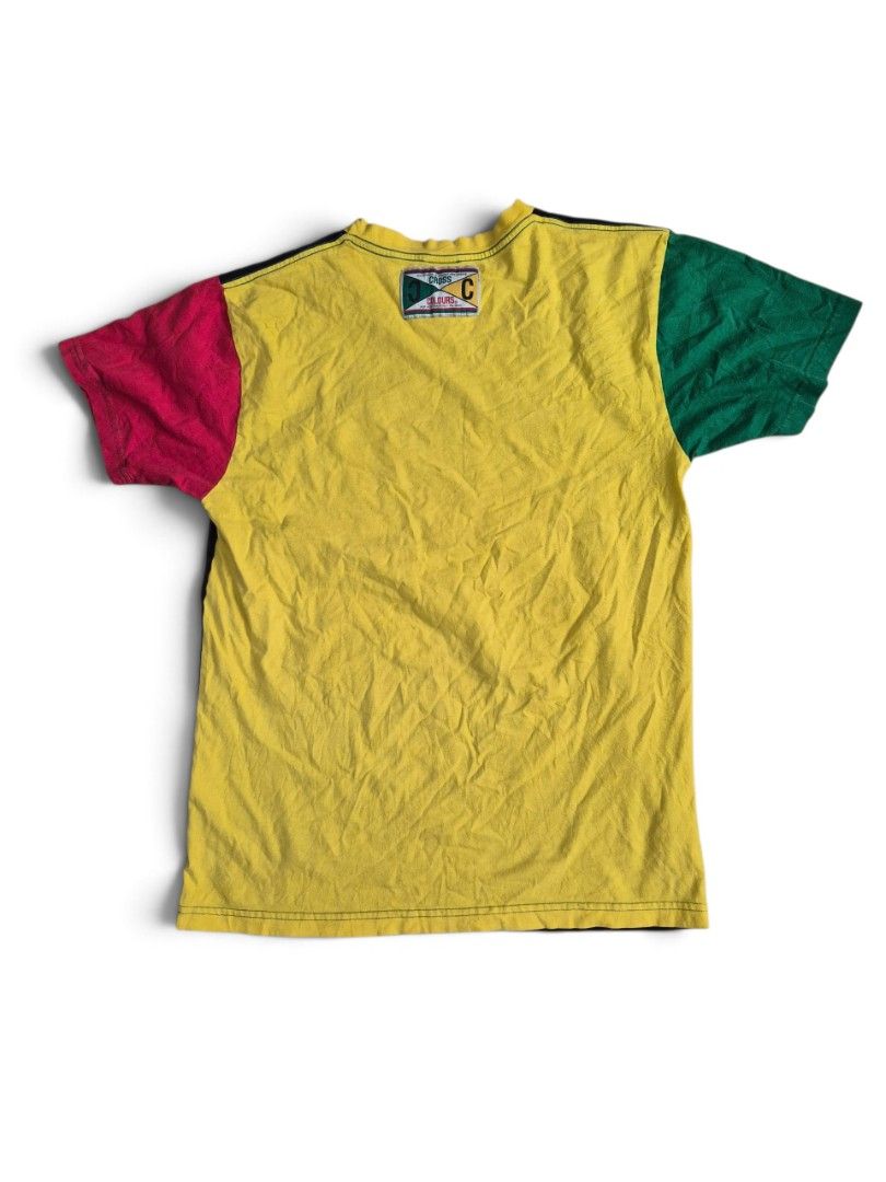 Vintage cross colours tee size medium on tag (Category: Activewear) located in Manila. Submitted by ifyouknowyouknow_ (Listing ID 1468331648, Image 2). Description: vintage Cross Colours black graphic t-shirt featuring a colorblocked design with a red right sleeve, a green left sleeve, a yellow crewneck collar, and a central graphic square with a yin-yang symbol. size medium on tag.