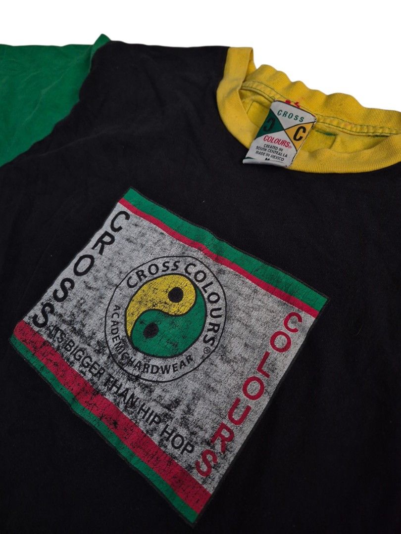 Vintage cross colours tee size medium on tag (Category: Activewear) located in Manila. Submitted by ifyouknowyouknow_ (Listing ID 1468331648, Image 3). Description: vintage Cross Colours black graphic t-shirt featuring a colorblocked design with a red right sleeve, a green left sleeve, a yellow crewneck collar, and a central graphic square with a yin-yang symbol. size medium on tag.