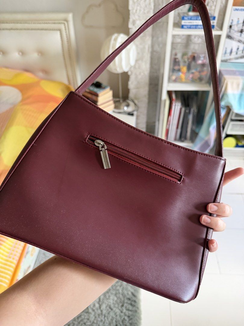 Vintage Esprit Burgundy Shoulder Bag (Category: Shoulder Bags) located in Cebu City. Submitted by sayonarasells (Listing ID 1468312347, Image 3). Description: - Brand: ESPRIT - Color: Rich deep burgundy / maroon - Style: Sleek rectangular shoulder bag with a slim strap - Storage: Secure top zipper closure, front slip pocket with metallic logo, and a convenient back zippered pocket - Versatility: Beautiful rich color that easily matches multiple o