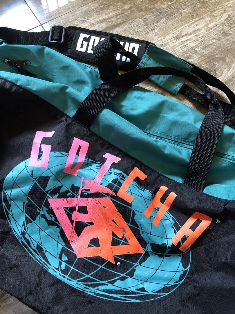 Vintage Gotcha Duffel Bag Teal & Black (Category: Other Sports Equipment and Supplies) located in Urdaneta. Submitted by byells (Listing ID 1468313065, Image 3). Description: Vintage Gotcha design Very spacious Includes shoulder strap Zipper working properly Design still intact have minor scratches only Overall no major issues .