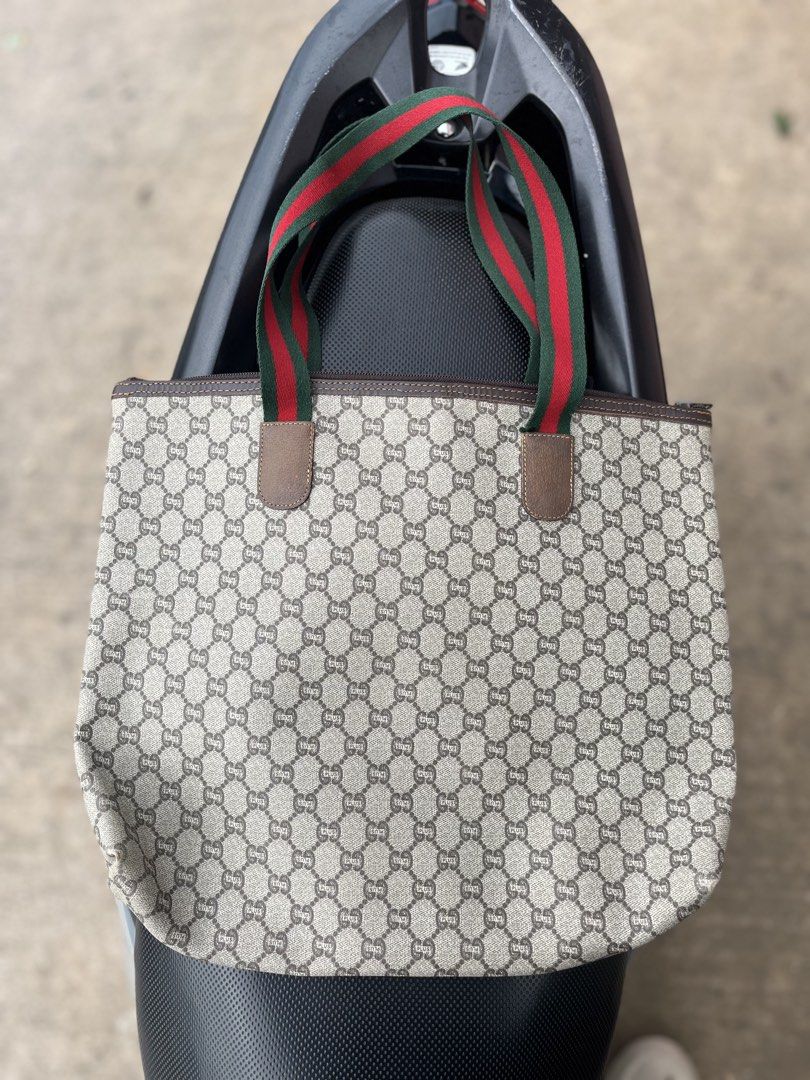 Vintage Gucci Plus Monogram Tote Bag (Category: Tote Bags) located in Tacloban City. Submitted by luxbag_phhh (Listing ID 1468341422, Image 2). Description: Gucci Plus monogram canvas tote bag with the classic green and red web stripe handles. Brown leather trim and gold-tone hardware badge on the front. Zip top closure. Inside features fabric lining with an internal slip pocket and leather brand tag stamped Made in Italy. Authentic.
