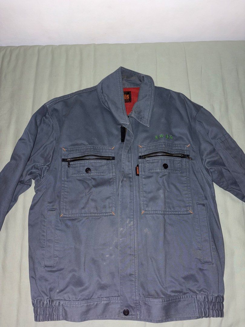 Vintage Japanese Blue Workwear Jacket (Category: Coats, Jackets and Outerwear) located in Manila. Submitted by silverjubilee (Listing ID 1468333024, Image 1). Description: - Brand/Model: Vintage grey work jacket - Size: L on tag but fits more on S-M - Pockets: Multiple zipped chest pockets with button closures - Fit/Cuffs: Elasticated cuffs and bottom hem - Details: Sturdy fabric build with Japanese embroidery text on the left chest - Condition: 