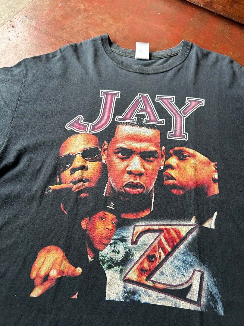 Vintage Jay-Z Graphic Rap Tee (Category: Tshirts & Polo Shirts ) located in Narvacan. Submitted by picky_looter (Listing ID 1468295578, Image 2). Description: - Vintage Jay-Z rap tee in dark charcoal grey - Size: XL (Gildan tag) - Front: Large photo graphic with "JAY Z" lettering - Back: "Hard Knock Life" graphic with stars - Condition: Washed, faded look with soft, worn fabric - Classic hip hop merchandise.