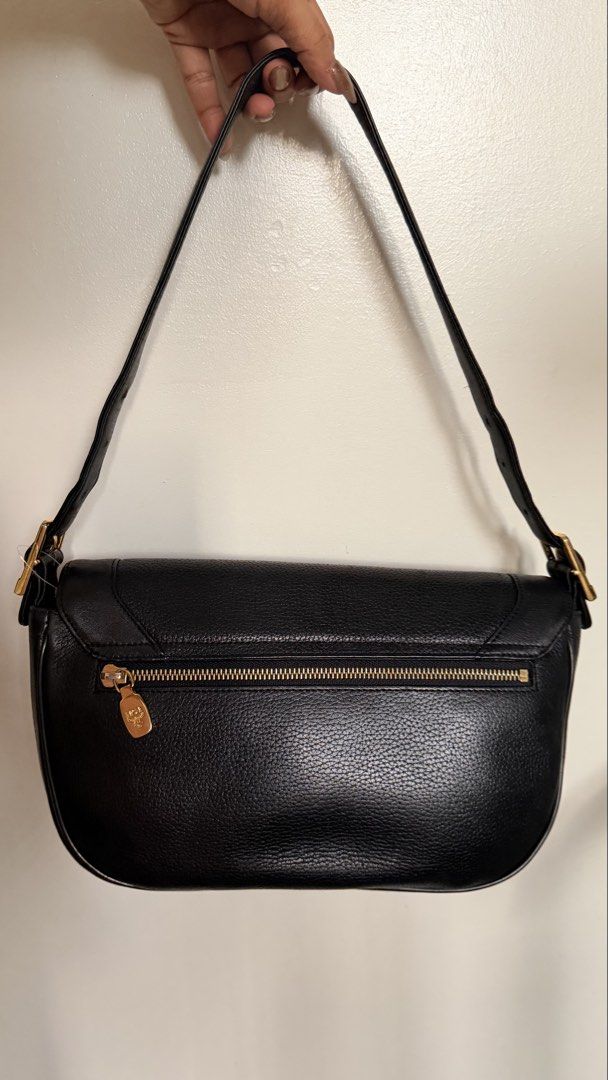 Vintage MCM Black Leather Shoulder Bag (Category: Luxury Bags & Wallets) located in Mandaluyong City. Submitted by sunsetblvd. (Listing ID 1468494302, Image 2). Description: Brand: MCM München Material: Premium black pebbled leather. Strap: Adjustable shoulder strap with buckle. Pockets: Convenient exterior back zipper pocket. Interior: Signature MCM monogram lining with gold metal brand plaque. Condition: well used, has some fades on hardware. N
