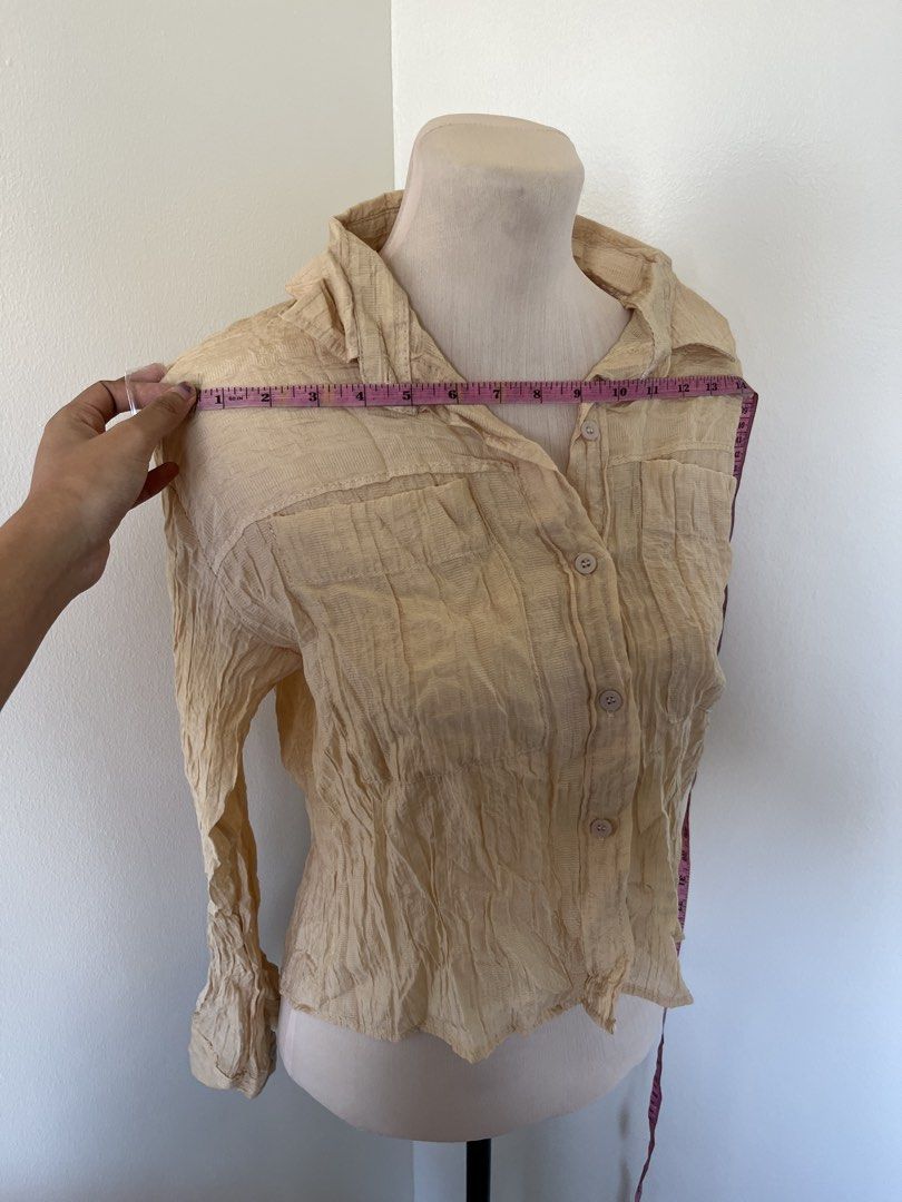 Vintage Textured Cream Button-Down Long Sleeve Blouse (Category: Blouses) located in Mandaluyong City. Submitted by bravedeer.020ad7 (Listing ID 1468366787, Image 2). Description: - Color: Cream - Style: Long-sleeve button-down with two chest pockets - Fabric: Lightweight, textured crinkle material - Size: 14" chest width, 18" length from shoulder - Condition/Use: Perfect basic piece for layering.