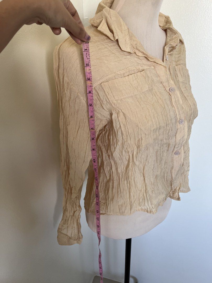Vintage Textured Cream Button-Down Long Sleeve Blouse (Category: Blouses) located in Mandaluyong City. Submitted by bravedeer.020ad7 (Listing ID 1468366787, Image 3). Description: - Color: Cream - Style: Long-sleeve button-down with two chest pockets - Fabric: Lightweight, textured crinkle material - Size: 14" chest width, 18" length from shoulder - Condition/Use: Perfect basic piece for layering.