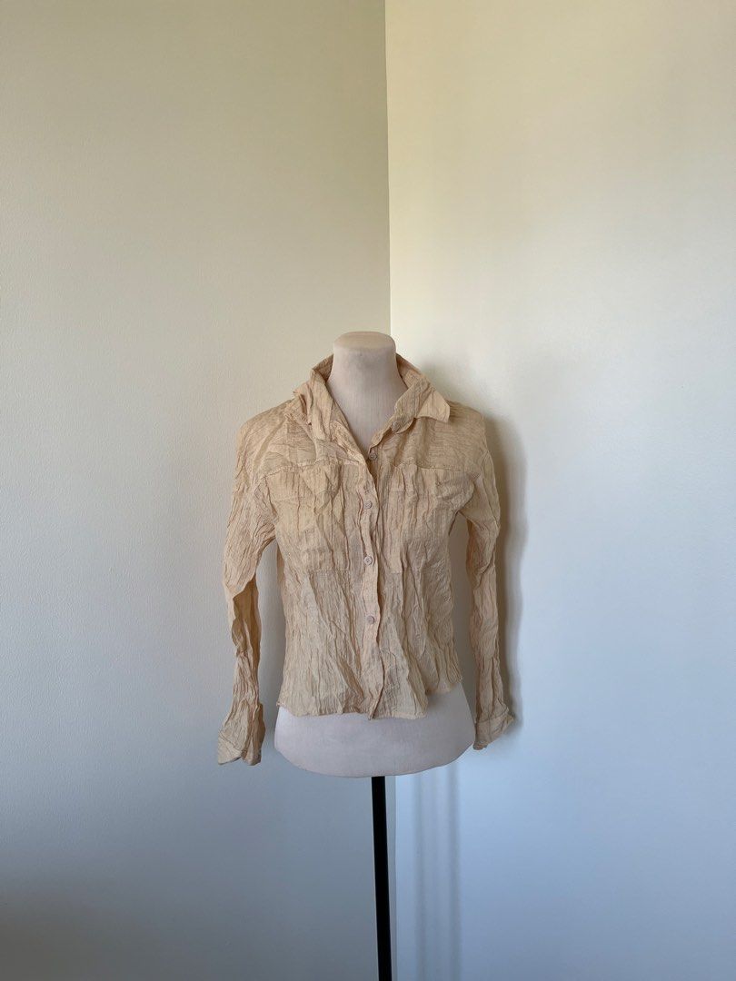 Vintage Textured Cream Button-Down Long Sleeve Blouse (Category: Blouses) located in Mandaluyong City. Submitted by bravedeer.020ad7 (Listing ID 1468366787, Image 1). Description: - Color: Cream - Style: Long-sleeve button-down with two chest pockets - Fabric: Lightweight, textured crinkle material - Size: 14" chest width, 18" length from shoulder - Condition/Use: Perfect basic piece for layering.