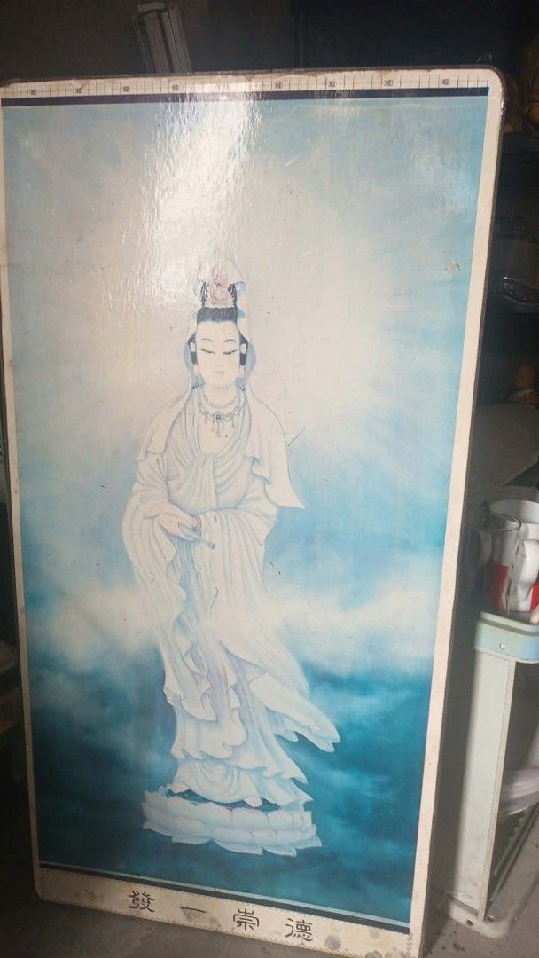 VINTAGE WOODEN BUDDHA DISPLAY (Category: Wall Decor) located in Mandaluyong City. Submitted by LEATHERFACE (Listing ID 1468324250, Image 1). Description: - Large vertical wall art featuring Guanyin Bodhisattva on lotus flowers against blue clouds - Adorned with traditional Chinese lettering at the bottom border - Sleek glossy finish with a clean white border frame - Ideal for home altars, temple spaces, or traditional interior decor.