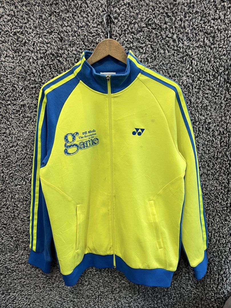 Vintage Yonex full-zip track jacket | Size L (Category: Coats, Jackets and Outerwear) located in General Trias. Submitted by zrchustle.604 (Listing ID 1468386188, Image 1). Description: vintage yellow and blue Yonex full-zip track jacket featuring blue stripe details on the sleeves, the Yonex logo on the left chest, and a large "No limit - The Revolution in the Game" graphic on the right chest..