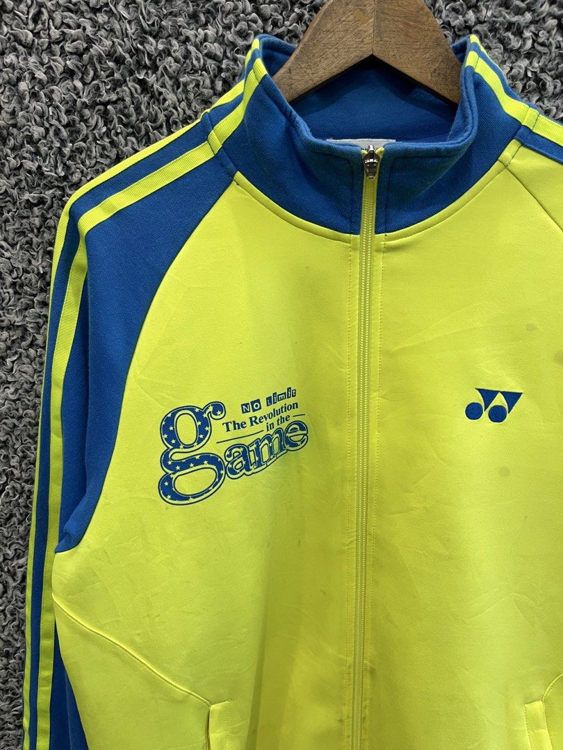 Vintage Yonex full-zip track jacket | Size L (Category: Coats, Jackets and Outerwear) located in General Trias. Submitted by zrchustle.604 (Listing ID 1468386188, Image 2). Description: vintage yellow and blue Yonex full-zip track jacket featuring blue stripe details on the sleeves, the Yonex logo on the left chest, and a large "No limit - The Revolution in the Game" graphic on the right chest..