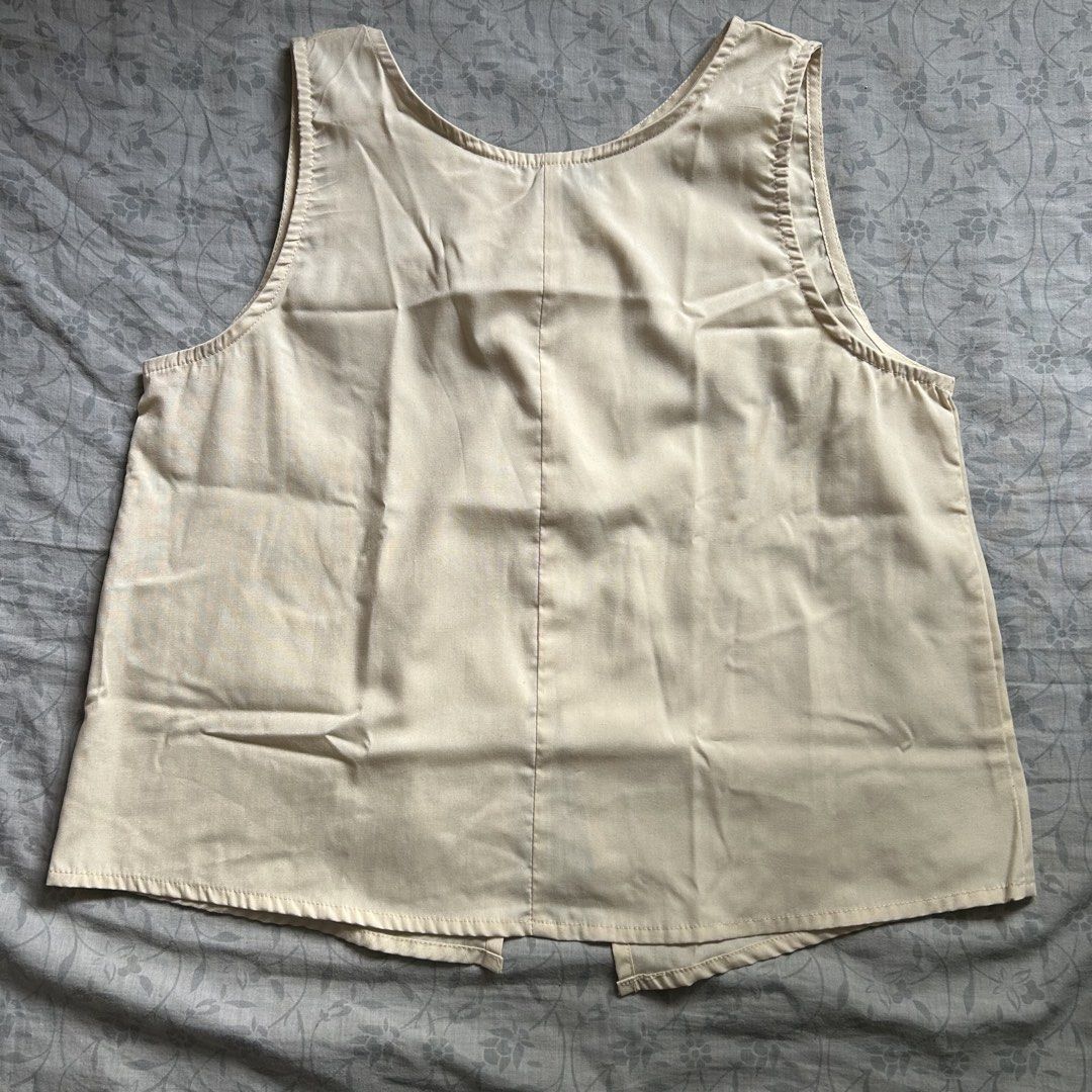 VONDA Beige Sleeveless Crop Top with Button Back (Category: Sleeveless) located in Manila. Submitted by frances_001 (Listing ID 1468334963, Image 1). Description: Color: Versatile neutral beige Style: Sleeveless crop top with high round neckline Detail: Unique crossover back with two upper buttons - Fabric: Lightweight and breathable for warm weather .