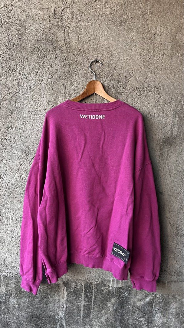We11done Magenta Logo Sweatshirt (Category: Coats, Jackets and Outerwear) located in Cabuyao City. Submitted by bulandos (Listing ID 1468377390, Image 2). Description: - Brand: We11done (Resort 2020 Collection) - Color: Bright Magenta - Size: Medium (Boxy, oversized fit) - Material: Heavyweight cotton & polyurethane blend (Made in Korea) - Details: Large metallic front logo, small back print, branding on right sleeve, and distressed hem.