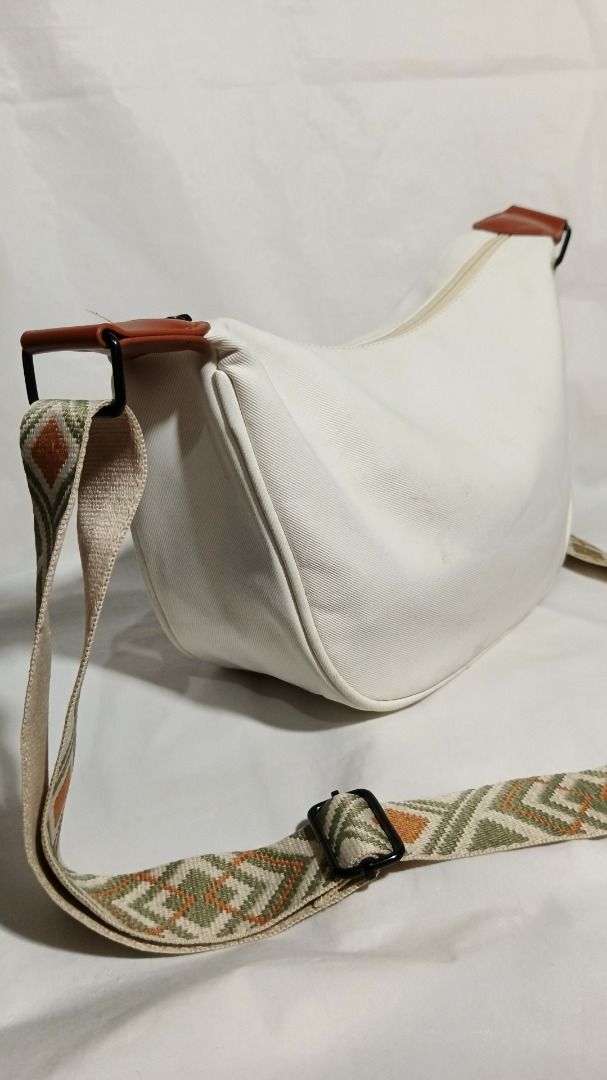 White Canvas Crossbody Bag with Geometric Pattern Strap (Category: Cross-body Bags) located in Baguio. Submitted by jdm.rvr24 (Listing ID 1468293543, Image 2). Description: *actual pictures posted* brand: Maitao dimension in inches; height: 7 length: 10.5 width / thickness: 4 division: 1 main zip, 1 back zip material: nylon canvas actual color: white color rate: 10/10 lock type: zipper working all zips adjustable strap condition: very good : need