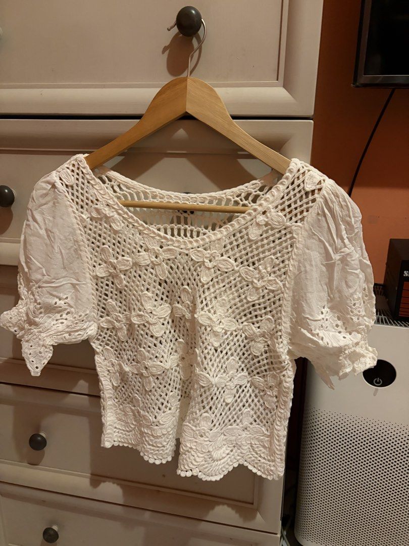 White Crochet Lace Top with Puff Sleeves (Category: Blouses) located in Quezon City. Submitted by mmiyah27 (Listing ID 1468370940, Image 1). Description: - once used only; recently bought for bora - Color: White - Material: Lightweight, breathable fabric - Design: Intricate open-work crochet lace with stitched flower details - Sleeves: Short puff sleeves with eyelet embroidery trim - Neckline: Scoop neckline - Styling: Perfect for warm weather; e