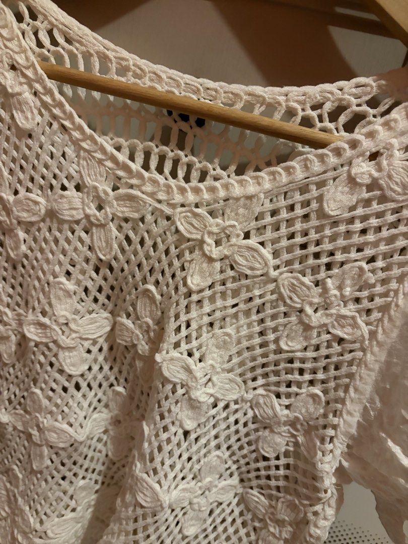 White Crochet Lace Top with Puff Sleeves (Category: Blouses) located in Quezon City. Submitted by mmiyah27 (Listing ID 1468370940, Image 2). Description: - once used only; recently bought for bora - Color: White - Material: Lightweight, breathable fabric - Design: Intricate open-work crochet lace with stitched flower details - Sleeves: Short puff sleeves with eyelet embroidery trim - Neckline: Scoop neckline - Styling: Perfect for warm weather; e
