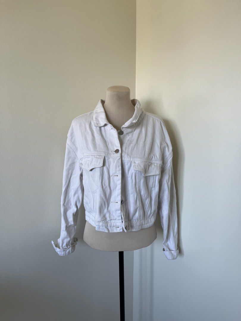 White Denim Jacket (Category: Coats, Jackets and Outerwear) located in Mandaluyong City. Submitted by bravedeer.020ad7 (Listing ID 1468365482, Image 1). Description: - Color: Bright white - Cut: Trendy cropped style - Closure: Classic button-down front with metal buttons - Pockets: Functional chest flap pockets - Details: Foldover collar and long sleeves with button cuffs - Fabric: Structured, durable denim.