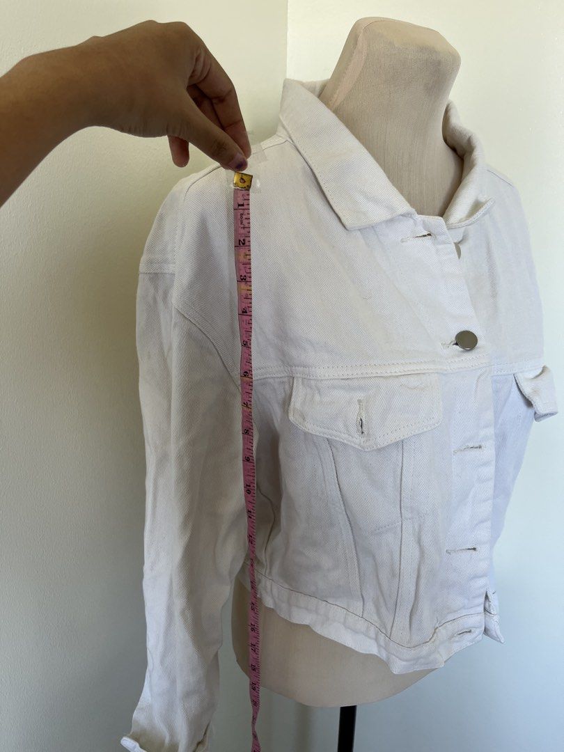 White Denim Jacket (Category: Coats, Jackets and Outerwear) located in Mandaluyong City. Submitted by bravedeer.020ad7 (Listing ID 1468365482, Image 3). Description: - Color: Bright white - Cut: Trendy cropped style - Closure: Classic button-down front with metal buttons - Pockets: Functional chest flap pockets - Details: Foldover collar and long sleeves with button cuffs - Fabric: Structured, durable denim.