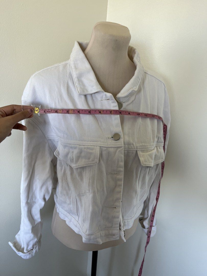 White Denim Jacket (Category: Coats, Jackets and Outerwear) located in Mandaluyong City. Submitted by bravedeer.020ad7 (Listing ID 1468365482, Image 2). Description: - Color: Bright white - Cut: Trendy cropped style - Closure: Classic button-down front with metal buttons - Pockets: Functional chest flap pockets - Details: Foldover collar and long sleeves with button cuffs - Fabric: Structured, durable denim.