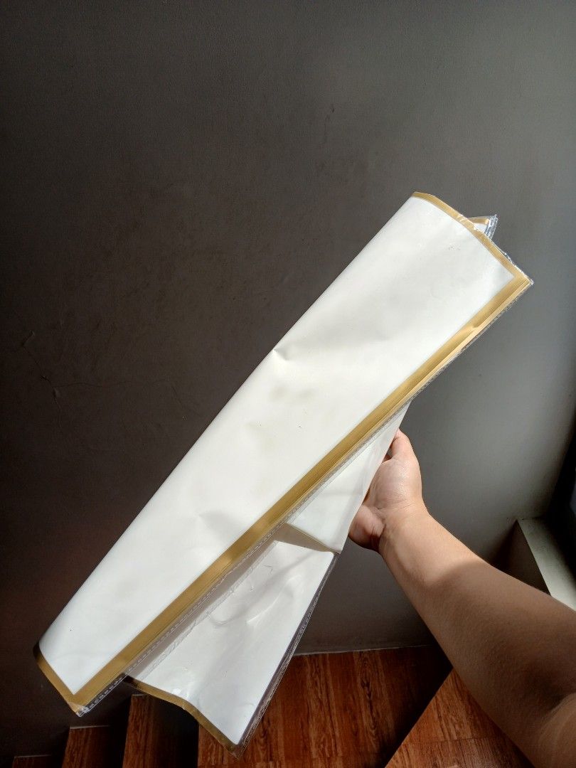 White flower wrapping paper with gold trim (Category: Flowers & Bouquets) located in Antipolo. Submitted by ukaylala (Listing ID 1468321868, Image 1). Description: Gold Border Wrapping paper hindi ko na po alam ilan ang natira, pero marami pa naman.