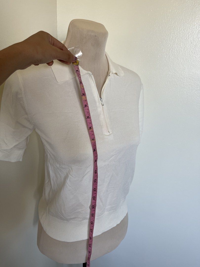 White Knit Polo Shirt with Zip Collar (Category: Tshirts & Polo Shirts ) located in Mandaluyong City. Submitted by bravedeer.020ad7 (Listing ID 1468367791, Image 2). Description: - Color: White - Style: Short sleeve knit top with polo collar and front zipper - Details: Ribbed hem and sleeve cuffs - Length: Approx. 21 inches down from the shoulder - Fabric: Soft and stretchy for all-day comfort - Fit: Great everyday basic for casual or smart-casua