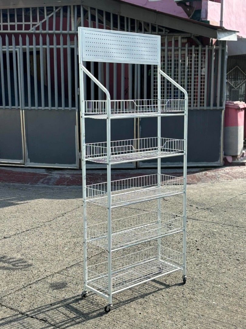 White Metal Wire 5-Tier Display Rack with Wheels (Category: Shelves, Cabinets & Racks) located in Manila. Submitted by ajimdolor012051 (Listing ID 1468326739, Image 1). Description: - Color/Finish: Clean white - Storage: 5 sturdy wire baskets for high visibility - Mobility: 4 smooth-rolling caster wheels - Features: Top perforated panel for signage or branding - Ideal for: Retail stores, bazaars, or home organization.