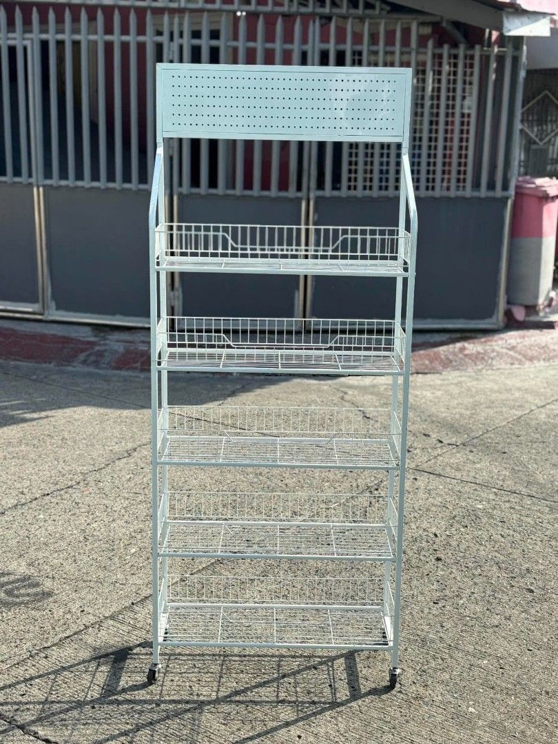 White Metal Wire 5-Tier Display Rack with Wheels (Category: Shelves, Cabinets & Racks) located in Manila. Submitted by ajimdolor012051 (Listing ID 1468326739, Image 3). Description: - Color/Finish: Clean white - Storage: 5 sturdy wire baskets for high visibility - Mobility: 4 smooth-rolling caster wheels - Features: Top perforated panel for signage or branding - Ideal for: Retail stores, bazaars, or home organization.
