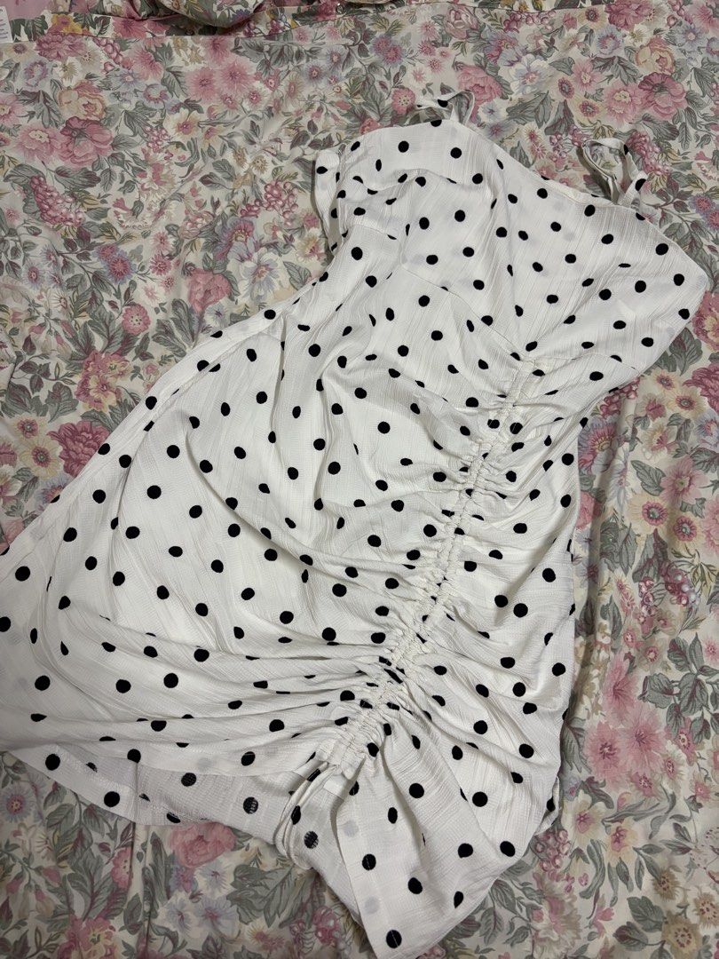 White Polka Dot Ruched Bodycon Dress (Category: Dresses) located in Manila. Submitted by urthrifthany (Listing ID 1468454538, Image 1). Description: - Color/Pattern: White with black polka dots - Features: Adjustable spaghetti straps, flattering ruched side detail - Fabric: Lightweight and textured, perfect for day or night - Condition: Worn once, clean, and ready to wear.