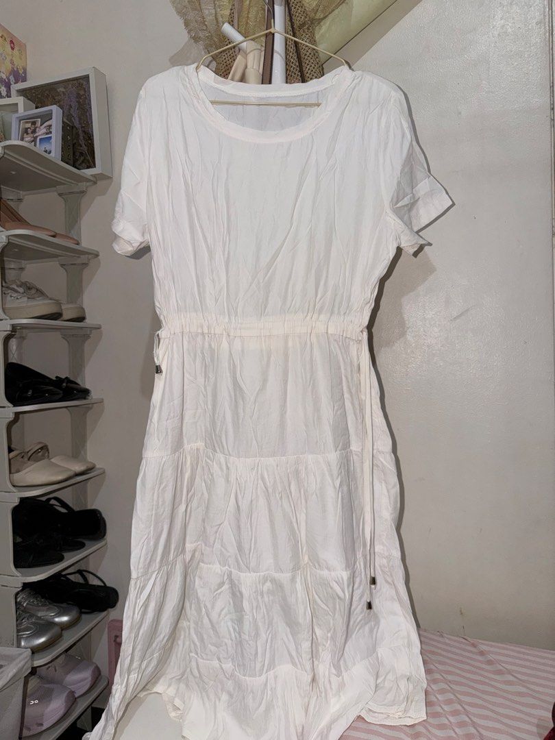 White tiered midi dress with drawstring waist (Category: Dresses) located in Taguig. Submitted by deguzmanke83356 (Listing ID 1468344343, Image 1). Description: - Color: White - Style: Casual midi dress - Details: Short sleeves, rounded neckline, adjustable drawstring waist - Design: Multi-panel tiered skirt - Fabric: Lightweight (note: has some wrinkling from storage) - Perfect for warm weather days!.