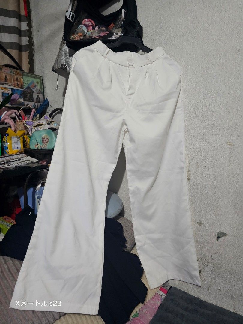 White wide leg trousers pants (Category: Jeans) located in Manila. Submitted by billydelar93312 (Listing ID 1468359372, Image 2). Description: size 26-27 150 each - Color: White - Style: Wide leg, relaxed fit - Waist: High waist with button and zipper fly - Details: Chic contrast stitching around pockets - Versatility: Ideal for casual and smart-casual outfits.