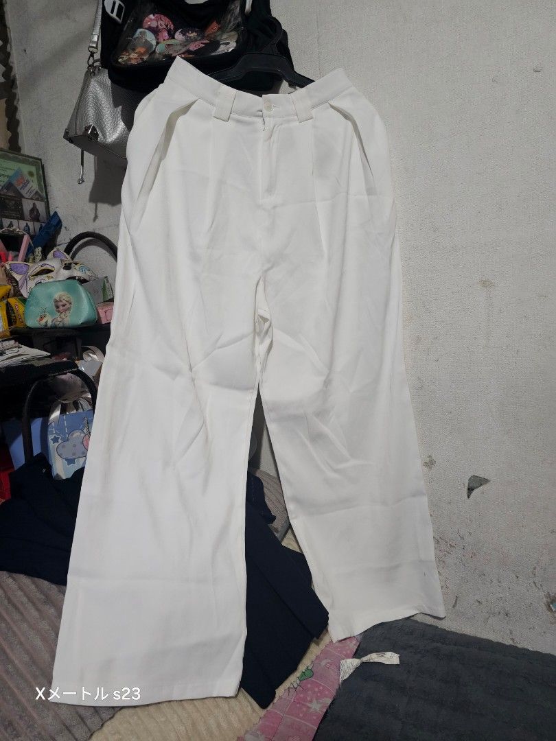 White wide leg trousers pants (Category: Jeans) located in Manila. Submitted by billydelar93312 (Listing ID 1468359372, Image 3). Description: size 26-27 150 each - Color: White - Style: Wide leg, relaxed fit - Waist: High waist with button and zipper fly - Details: Chic contrast stitching around pockets - Versatility: Ideal for casual and smart-casual outfits.