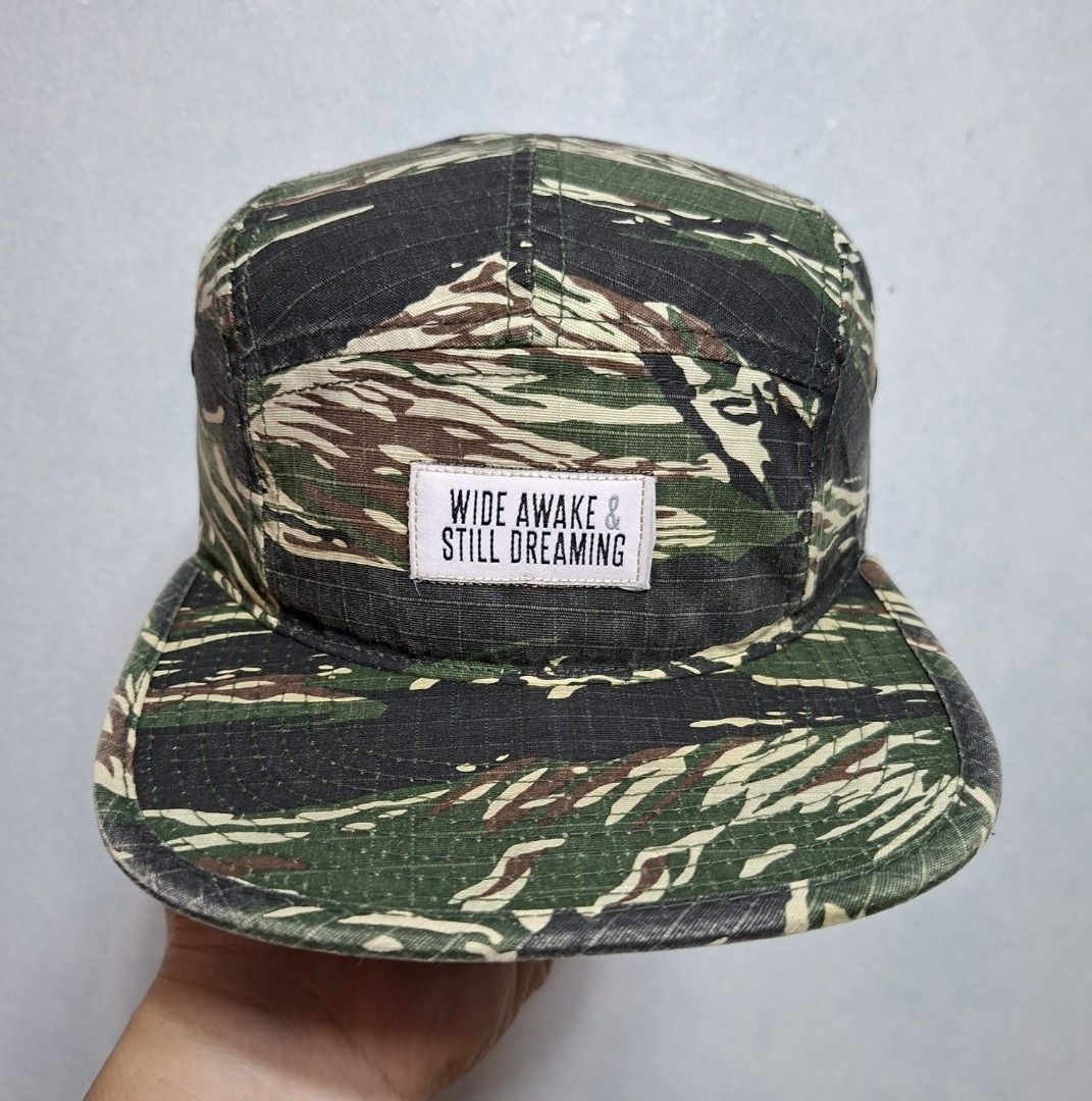 Wide Awake Still Dreaming Camo 5-Panel Hat (Category: Caps & Hats) located in Taguig. Submitted by AlfonsoJaimepreloved (Listing ID 1468461719, Image 1). Description: Wide Awake & Still Dreaming Camou 5 Panel Hat By : Yupoong Adult / Seat Belt type Embroidered / 100% Cotton Camouflage Colorway Issue : - have unnoticeable ripped both side of the upper brim Price : 480 Location : ibayo Tipas Taguig City MOD : Lalamove / LBC / J&T at buyer expense M