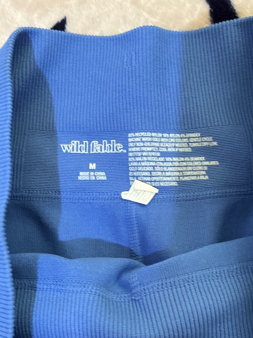 Wild Fable Blue Ribbed Athletic Shorts (Category: Activewear) located in Batangas. Submitted by lilirosie (Listing ID 1468344744, Image 2). Description: - Brand: Wild Fable - Size: Medium - Color: Bright blue with white piping trim - Material: Soft knit fabric with recycled nylon and spandex - Fit: High waistband - Condition: Great for workouts or casual lounging - Can fit to small din.