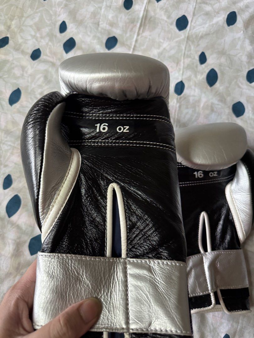 Winning Boxing Gloves 16 oz Silver and Black (Category: Combat Sports) located in Manila. Submitted by seangoart (Listing ID 1468350809, Image 3). Description: - Brand: Winning - Size: 16 oz - Color: Black and silver - Closure: Secure hook and loop - Material: Premium leather - Features: Solid wrist support, superior padding, and iconic wrist logo patch - Best for: Sparring and heavy bag workouts.