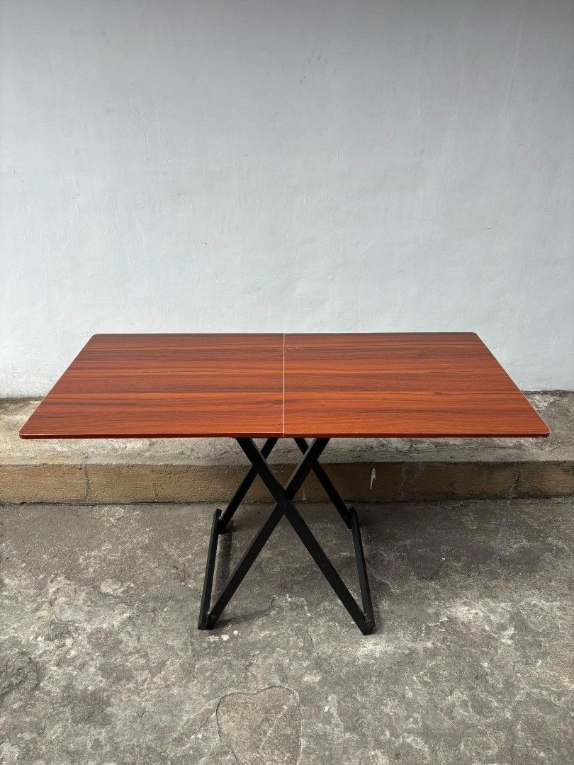 Wooden Top Folding Dining Table with Metal Scissors Frame (Category: Tables & Sets) located in Manila. Submitted by ajimdolor012051 (Listing ID 1468325916, Image 1). Description: - Rectangular wooden top with a rich brown grain finish - Sturdy black metal base with a folding scissor mechanism - Folds flat completely for effortless storage - Excellent space-saver ideal for compact apartments or multi-use rooms - 120cm ang haba.