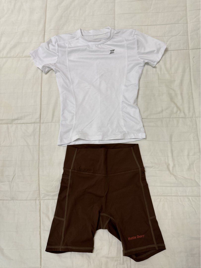 Workout Set (Category: Activewear) located in Quezon City. Submitted by m3gan8 (Listing ID 1468380386, Image 2). Description: - 2-piece activewear set (sold together) - White short-sleeve athletic top with a subtle logo on the chest - High-waisted brown biker shorts with convenient side pockets - Cute 'Hottie Diary' print near the short hem - Stretchy, comfortable fabric ideal for gym workouts, running, or casual wear.