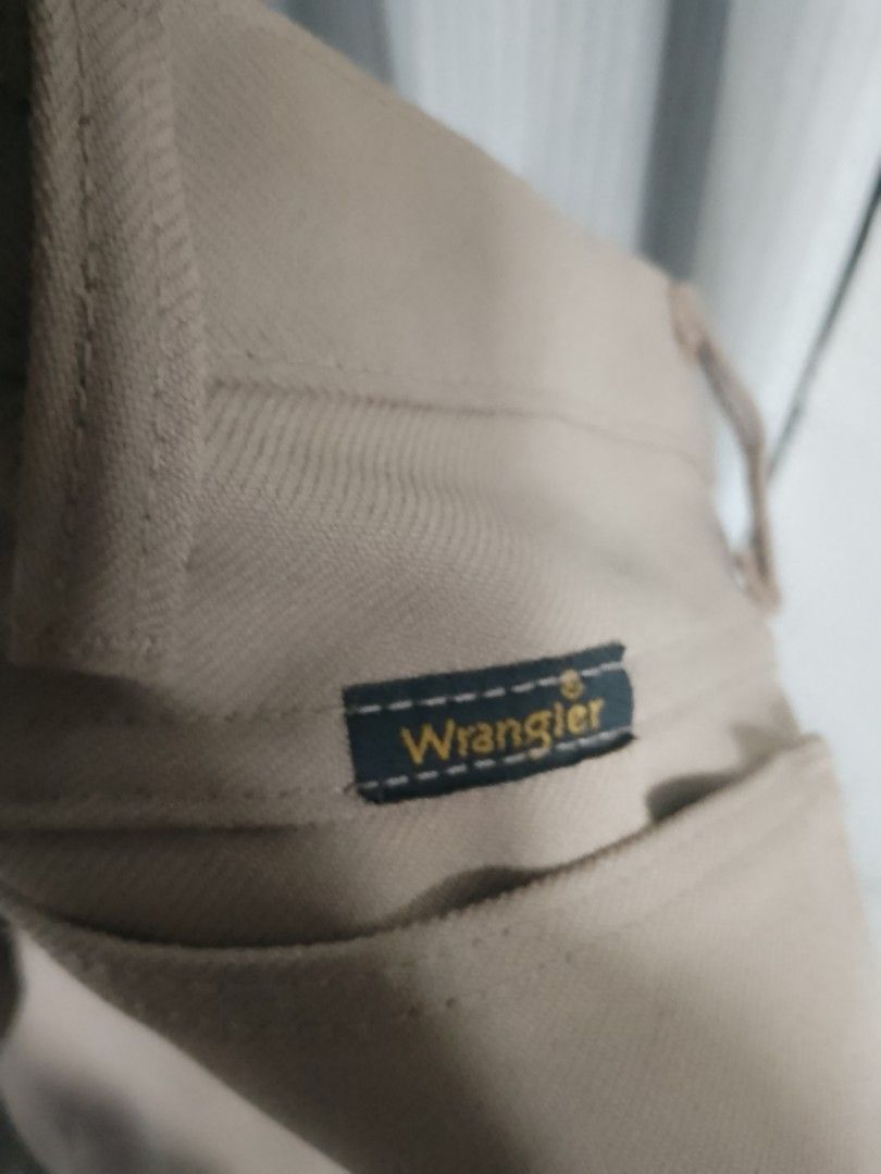 Wrangler Khaki Pants Trousers (Category: Trousers) located in Manila. Submitted by warmtiger.a2c491 (Listing ID 1468361002, Image 2). Description: - Brand: Wrangler - Color: Khaki - Style: Classic casual trousers - Features: Sturdy fabric, belt loops, and standard pockets - Condition: Clean overall - Versatility: Great everyday staple that easily matches with tees or button-downs.