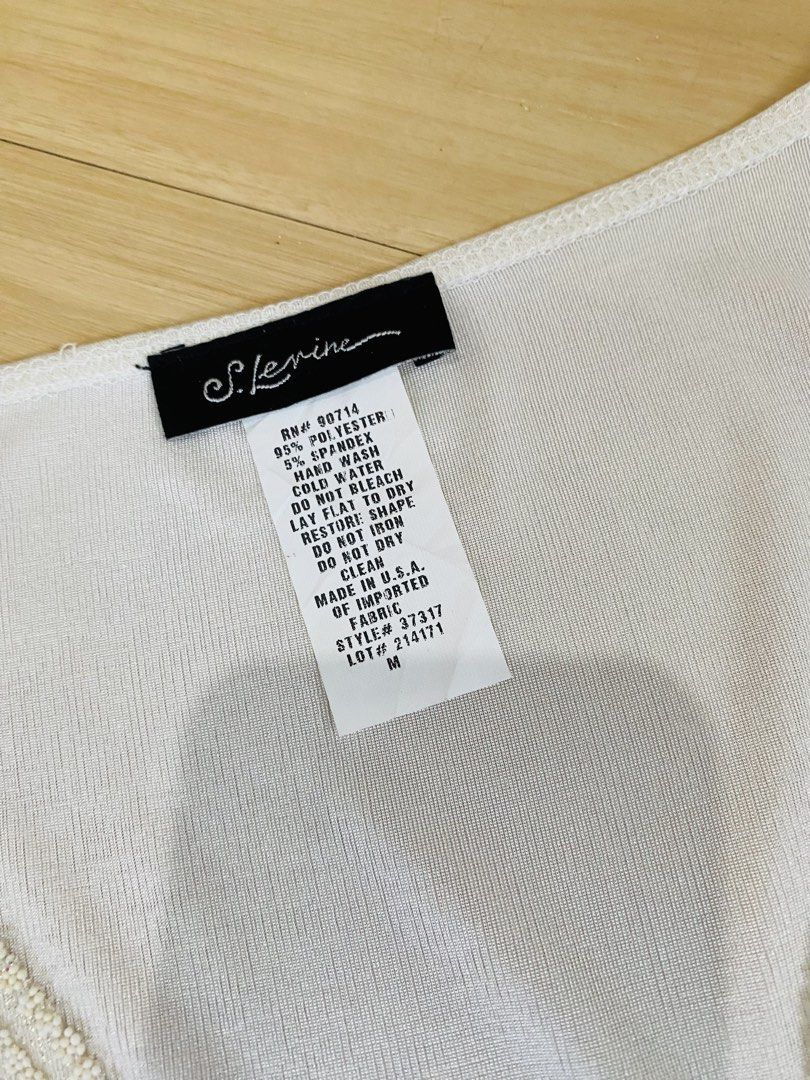 Y2k Beaded White Sleeveless Top Size M (Category: Sleeveless) located in Vigan. Submitted by yourcloset1001 (Listing ID 1468468337, Image 3). Description: - Brand: S. Levine - Color: White - Size: M (Made in USA) - Material: 95% polyester, 5% spandex (lightweight with stretch) - Design: Scoop neck with intricate beadwork along the neckline and a pointed, zigzag beaded hemline - Condition: Excellent pre-loved condition - Perfect for casual outings